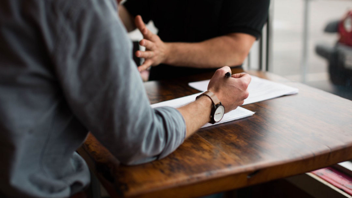 men make an agreement sitting on the table